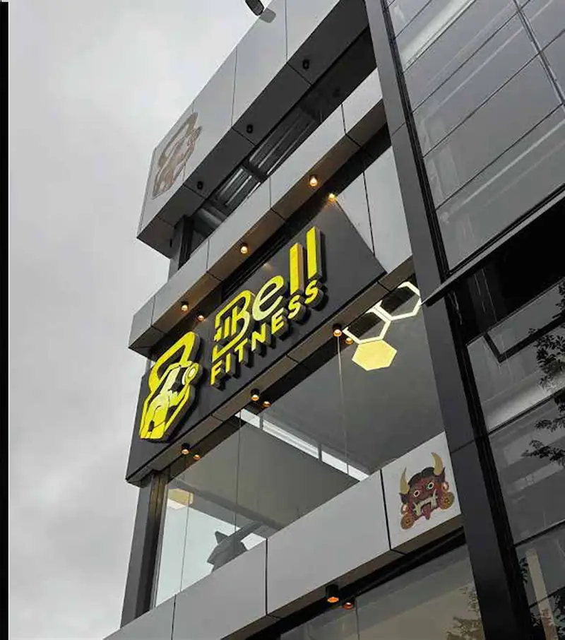 Bell Fitness illuminated signage on a multi-storey facade
