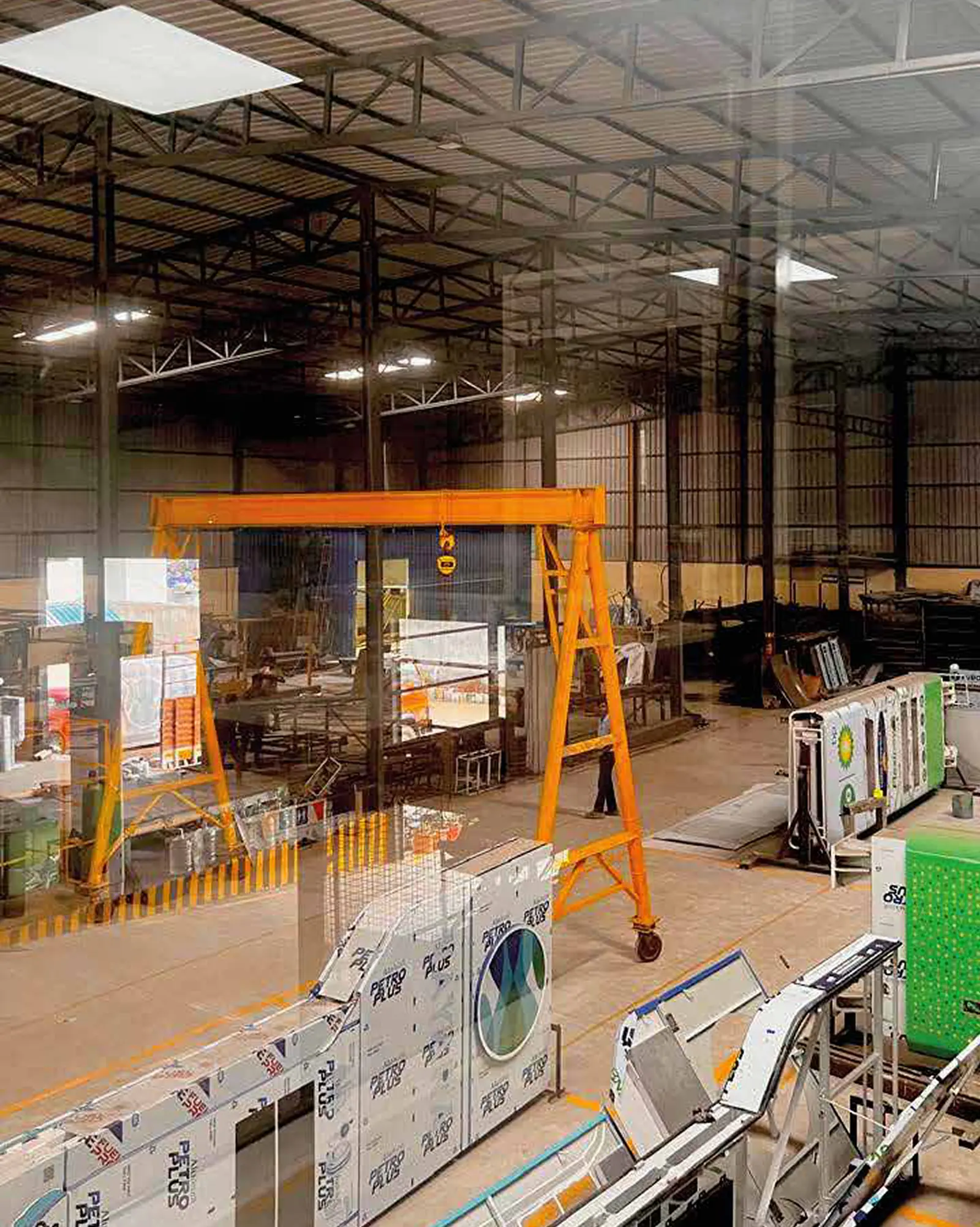 Inside the IndiSign manufacturing facility, with gantry crane and fabricated signage components
